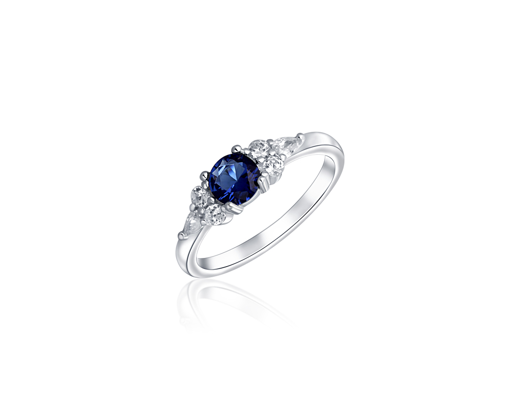 JVD Dámský zásnubný stříbrný prsten se zirkony a modrým safírem SVLR0471XF6M156