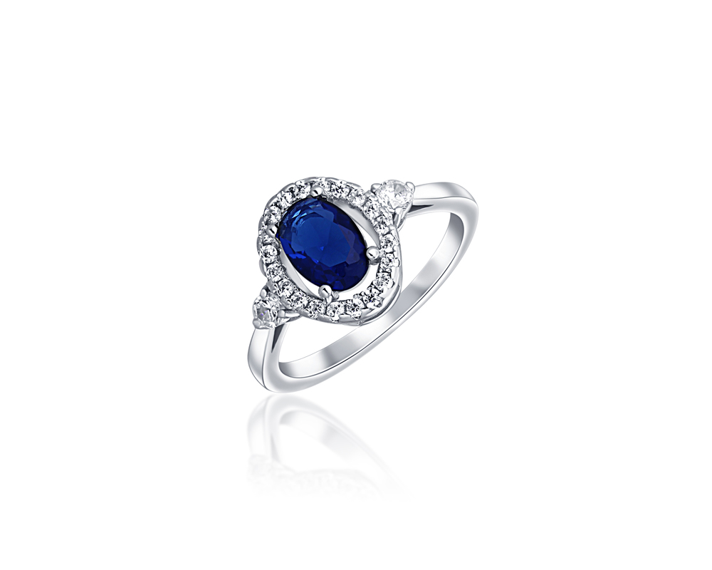 JVD Dámský zásnubný stříbrný prsten se zirkony a modrým safírem SVLR0497XH2M152